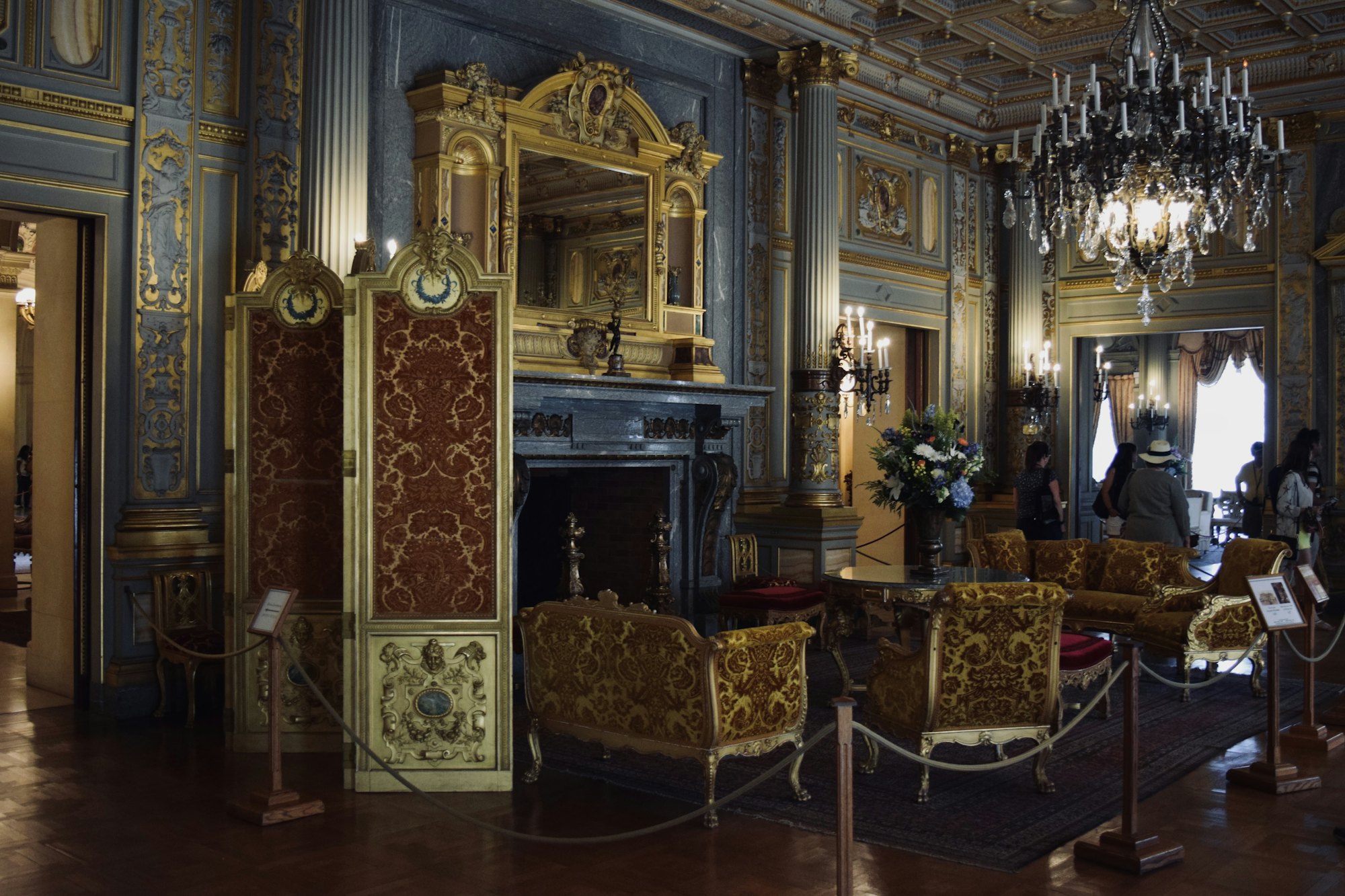A gilded drawing room with chandeliers